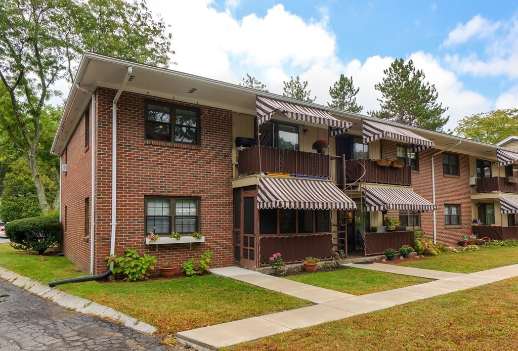 84 Renwick Road, Unit C Wakefield, MA 01880 - Photo 24 of 29 a front view of a house with a yard