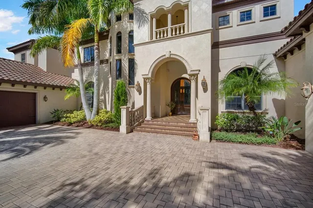 a kitchen with stainless steel appliances granite countertop a sink a stove and cabinets