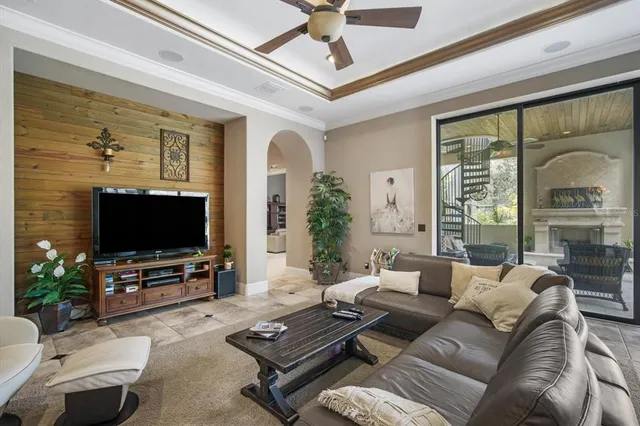 a living room with furniture and a chandelier