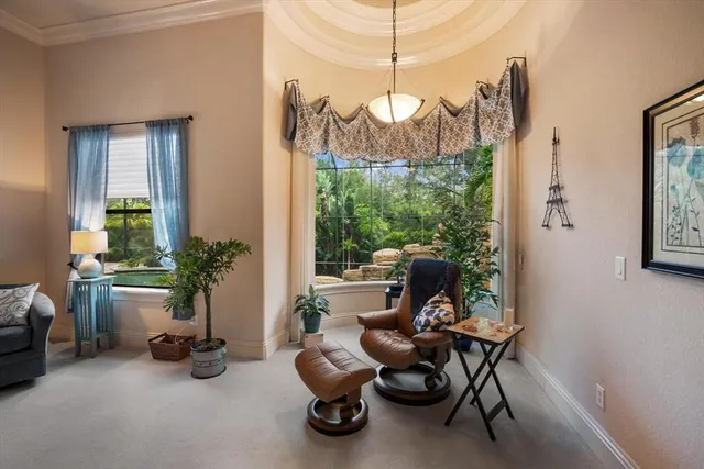 a view of a hallway with wooden floor and windows