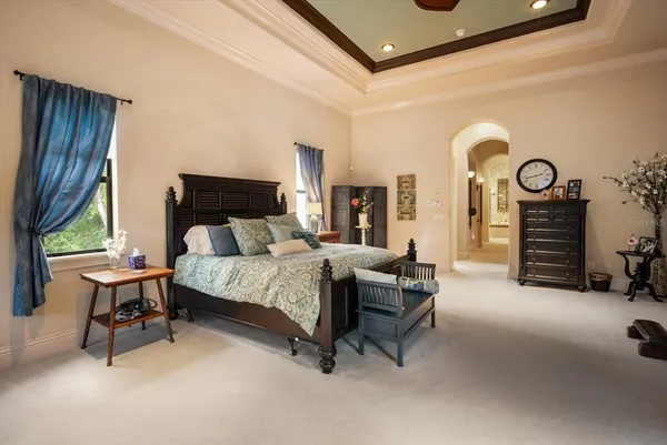 a bedroom with a bed and a chandelier
