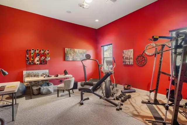 a living room with furniture kitchen view and a chandelier