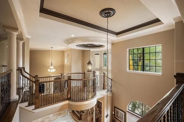 a bedroom with a bed a chandelier and a large window