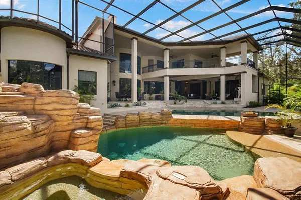 an aerial view of residential house with outdoor space and swimming pool