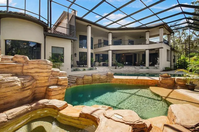 an aerial view of residential house with outdoor space and swimming pool