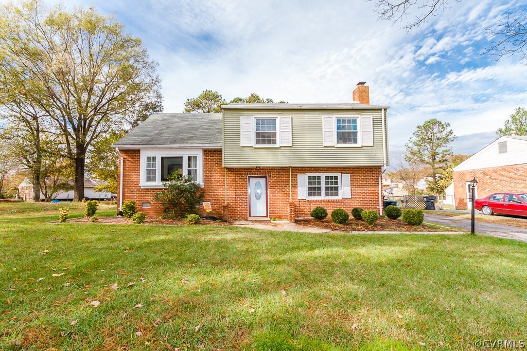 6332 Barrister Road Chesterfield, VA 23832 - Photo 24 of 24 a view of a yard in front of a brick house with many windows