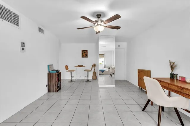 a living room with furniture a table and chairs