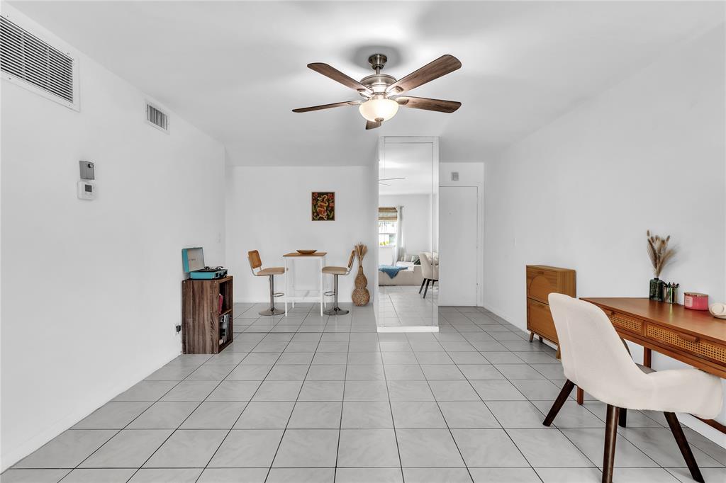 1950 North Andrews Avenue, Unit 210D Wilton Manors, FL 33305 - Photo 12 of 52 a living room with furniture and white walls