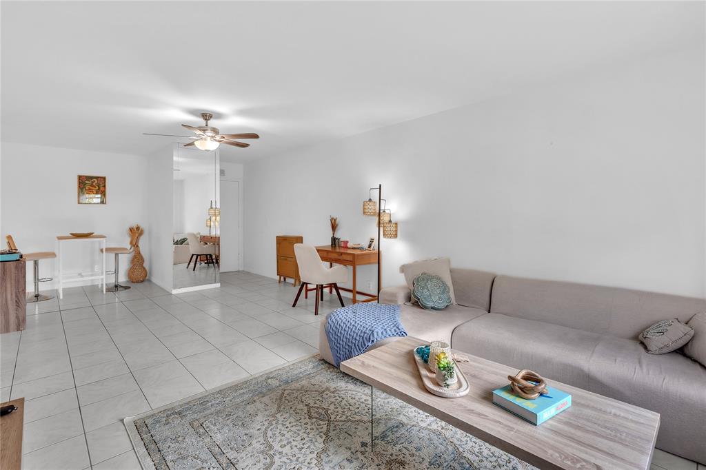 1950 North Andrews Avenue, Unit 210D Wilton Manors, FL 33305 - Photo 17 of 52 a living room with furniture and wooden floor