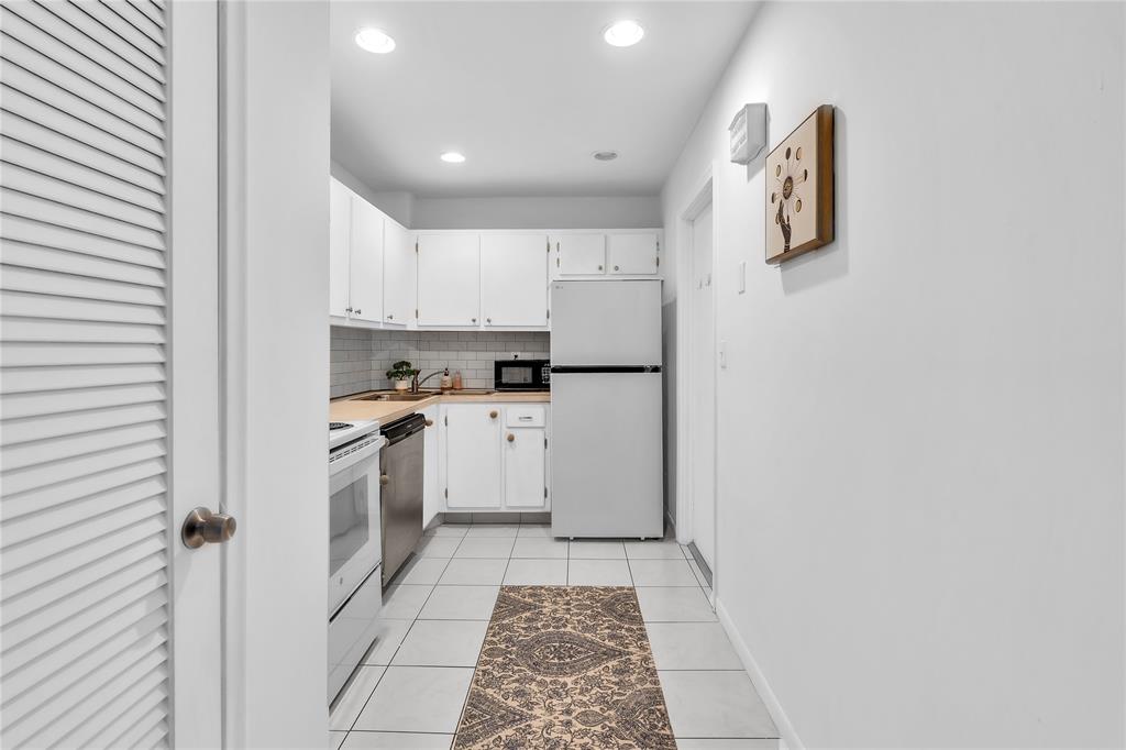 1950 North Andrews Avenue, Unit 210D Wilton Manors, FL 33305 - Photo 21 of 52 a kitchen with cabinets oven and a sink