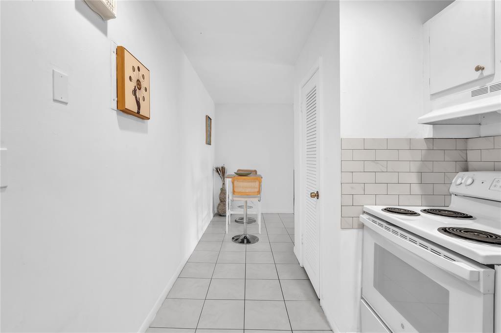 1950 North Andrews Avenue, Unit 210D Wilton Manors, FL 33305 - Photo 25 of 52 a hallway with washer and dryer