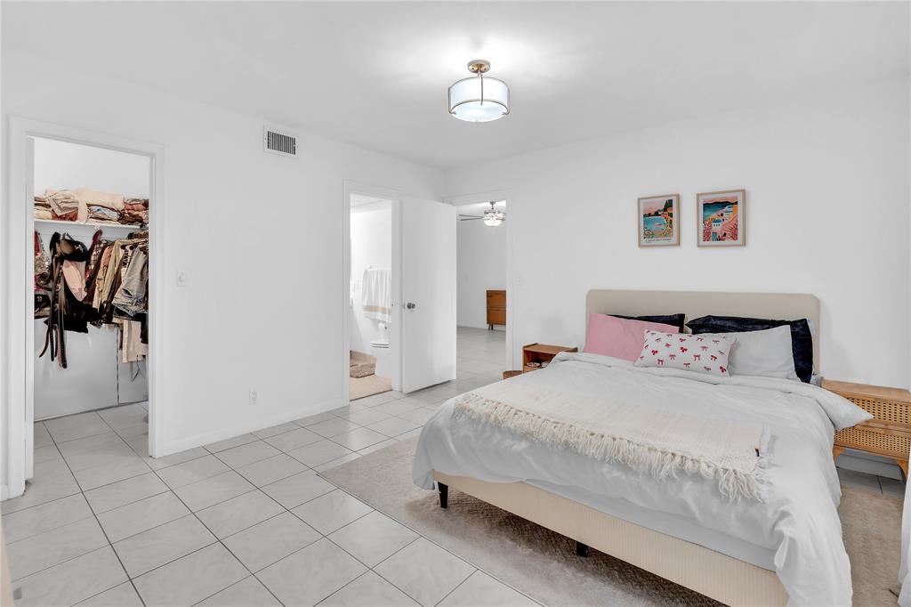 1950 North Andrews Avenue, Unit 210D Wilton Manors, FL 33305 - Photo 29 of 52 a bedroom with a bed and a view of bathroom