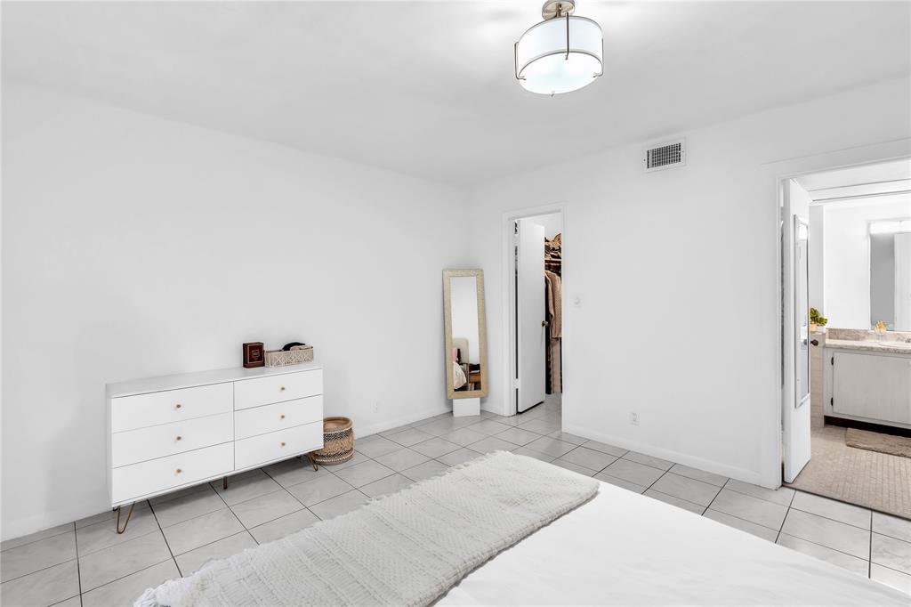 1950 North Andrews Avenue, Unit 210D Wilton Manors, FL 33305 - Photo 30 of 52 a room with a bed and a chandelier