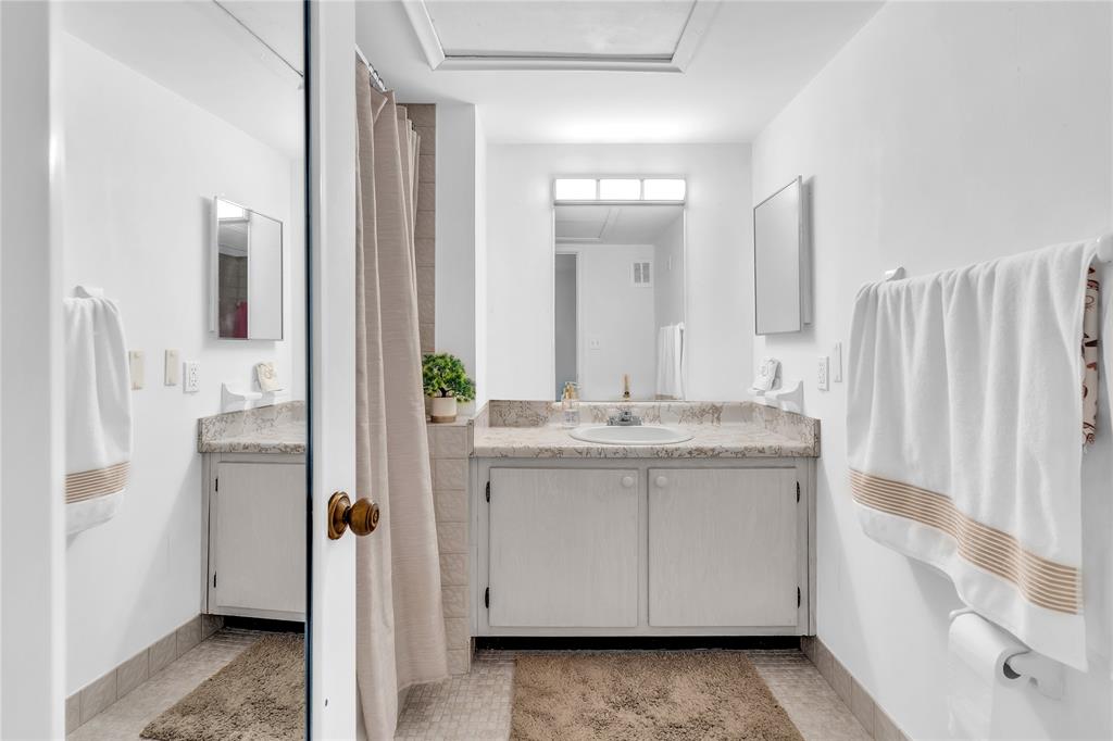 1950 North Andrews Avenue, Unit 210D Wilton Manors, FL 33305 - Photo 34 of 52 a bathroom with a double vanity sink and mirror