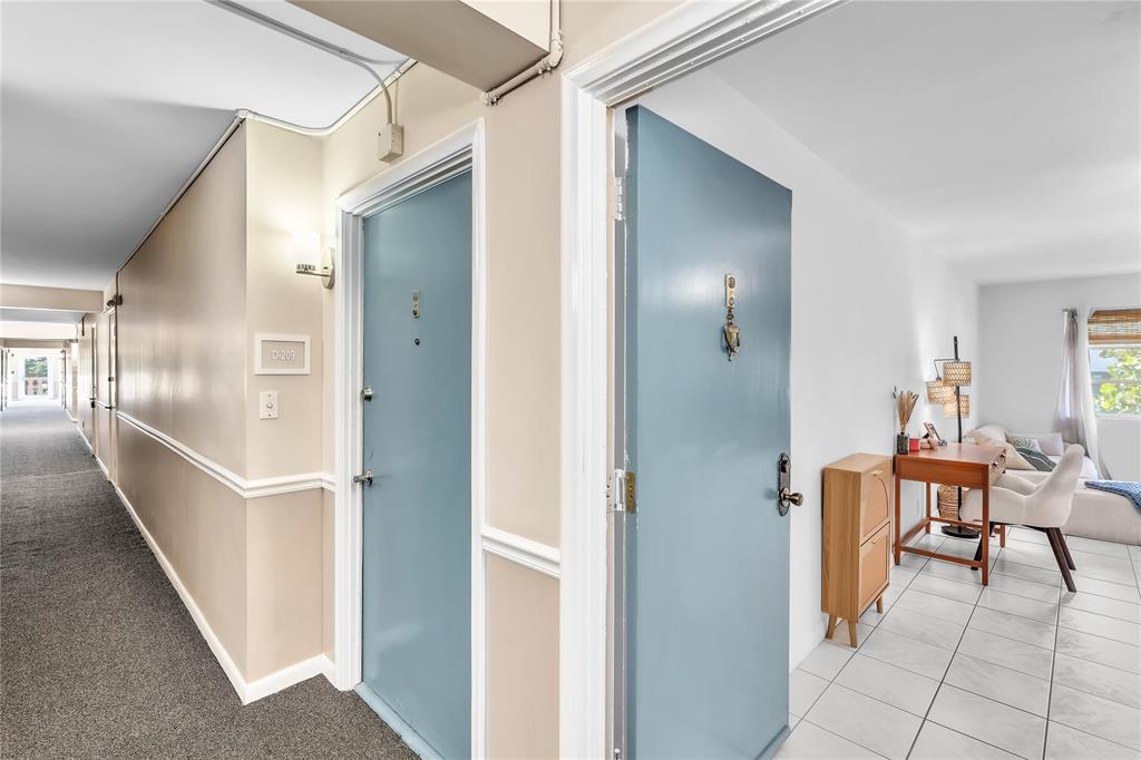1950 North Andrews Avenue, Unit 210D Wilton Manors, FL 33305 - Photo 4 of 52 a view of a hallway with furniture and a window