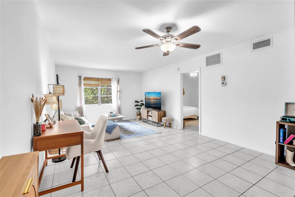 1950 North Andrews Avenue, Unit 210D Wilton Manors, FL 33305 - Photo 6 of 52 a living room with furniture and a window