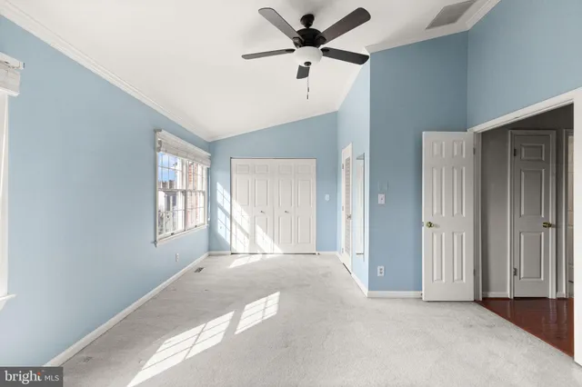 a view of a livingroom with a window and a ceiling fan