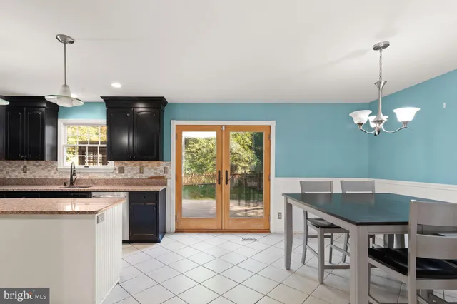 a kitchen with granite countertop a sink a counter top space and appliances