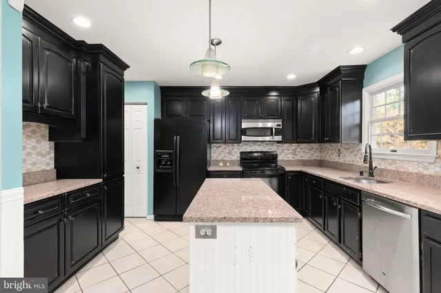 a kitchen with a sink stainless steel appliances and cabinets