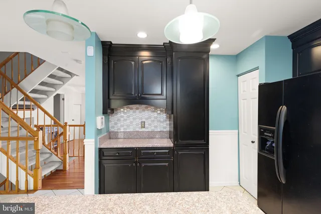 a kitchen with stainless steel appliances kitchen island granite countertop a refrigerator and a stove