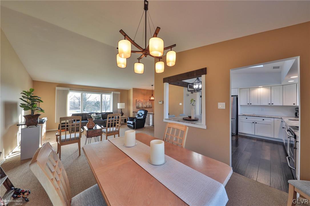 667 Bower Road Nazareth, PA 18064 - Photo 10 of 40 a view of a dining room and livingroom with furniture wooden floor a chandelier