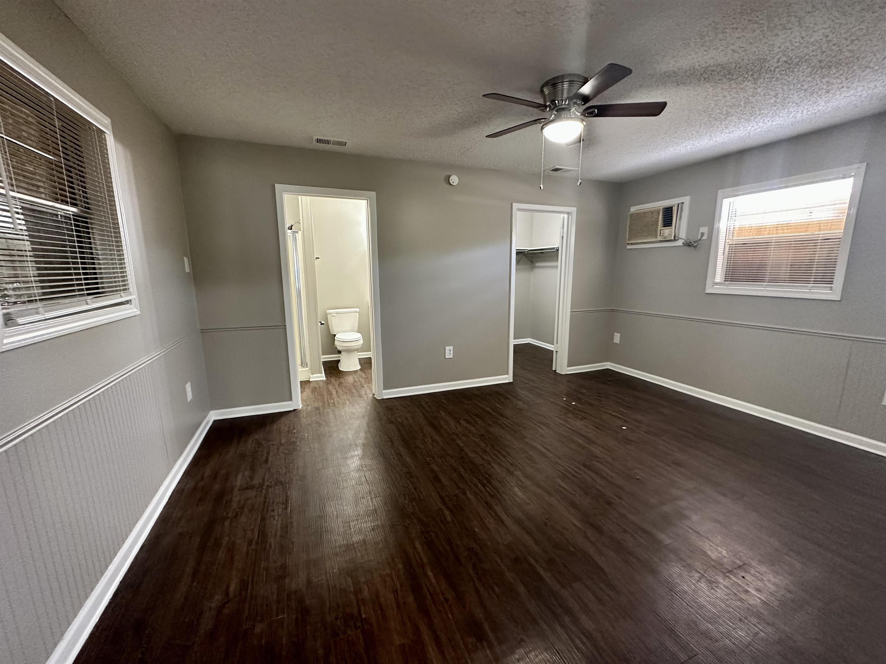 296 Glencoe Road Memphis, TN 38109 - Photo 11 of 18 a view of an empty room with wooden floor and a window