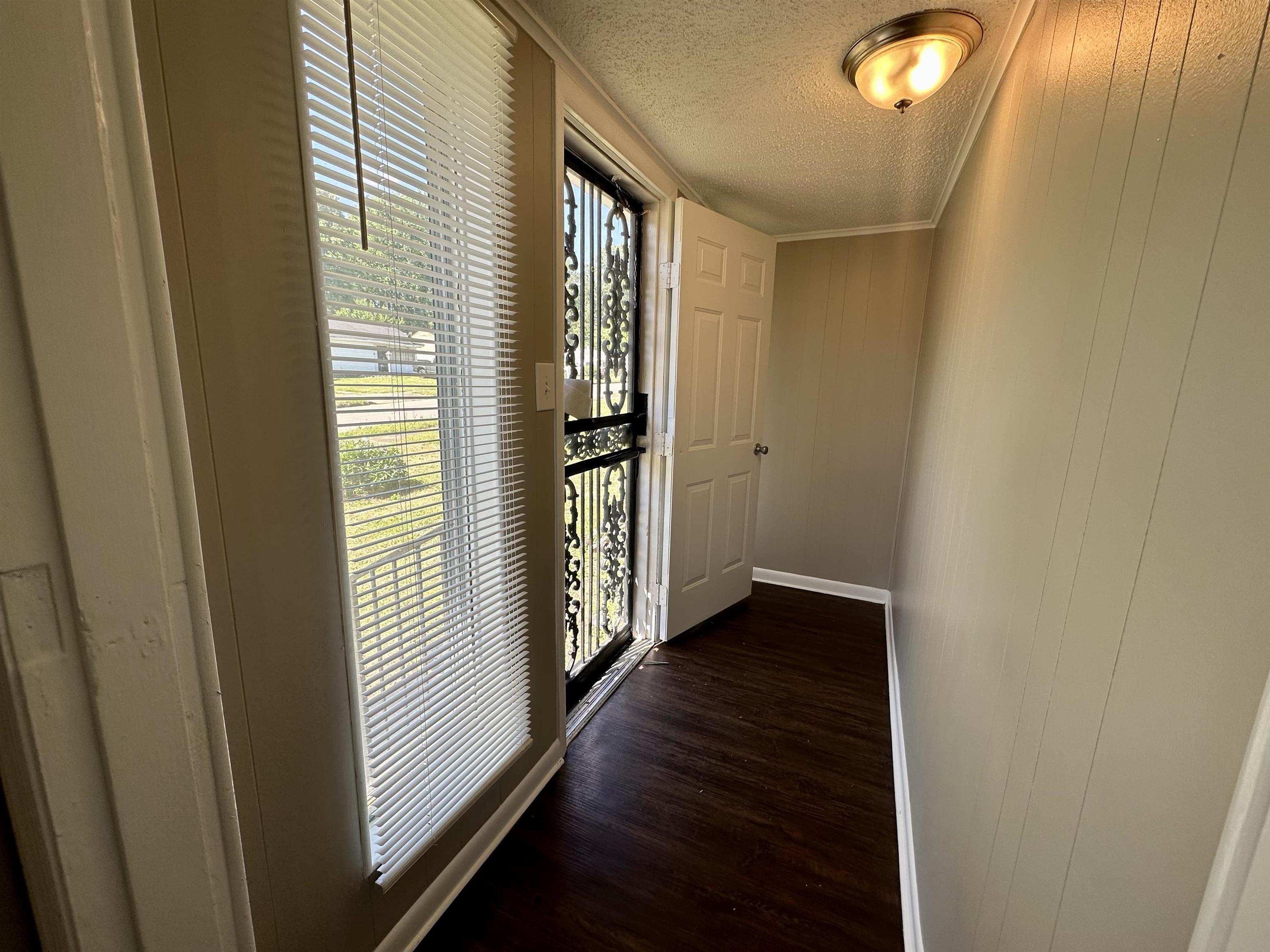 296 Glencoe Road Memphis, TN 38109 - Photo 15 of 18 a view of a hallway with wooden floor and closet