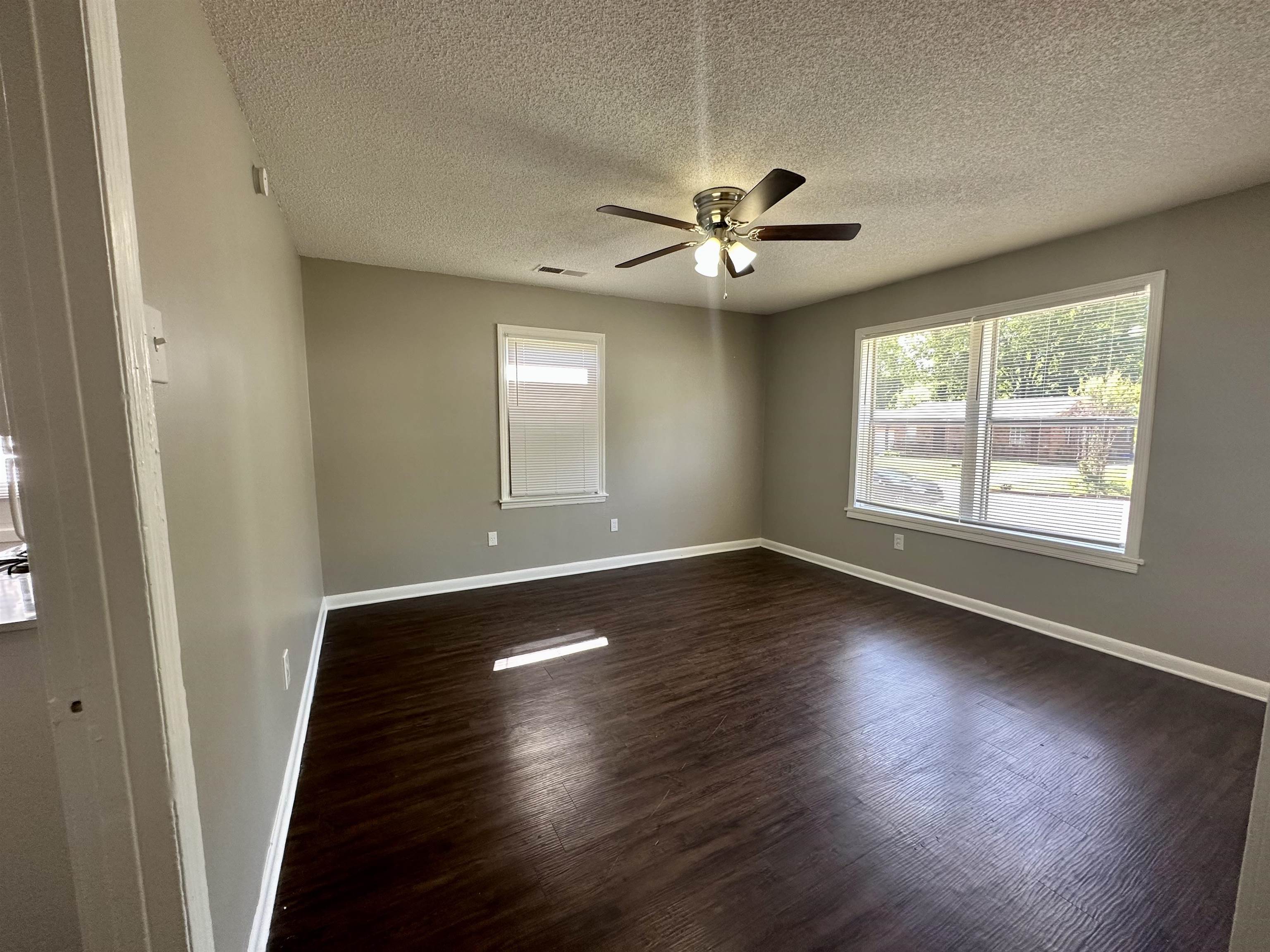 296 Glencoe Road Memphis, TN 38109 - Photo 16 of 18 a view of an empty room with wooden floor and a window