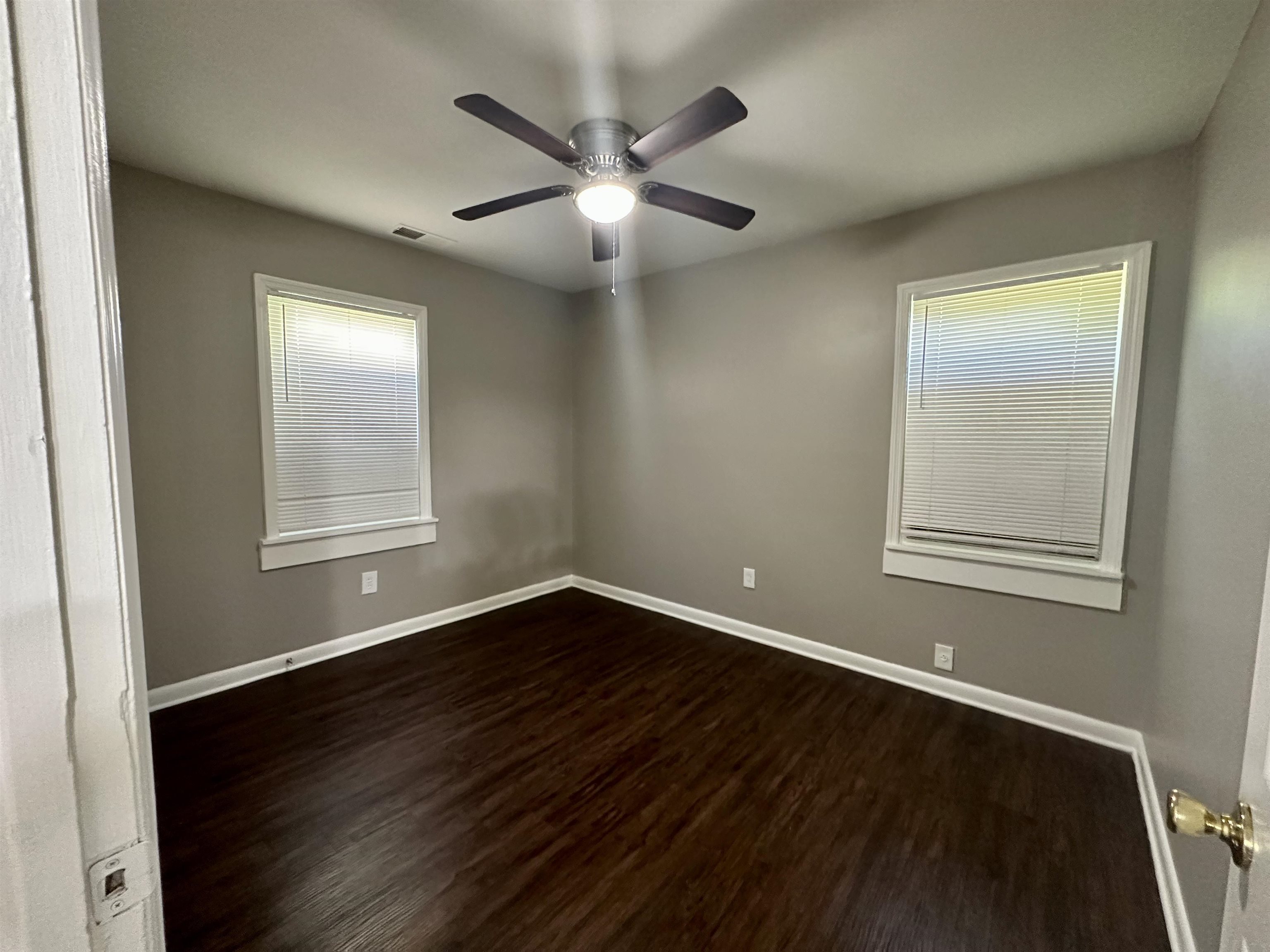 296 Glencoe Road Memphis, TN 38109 - Photo 18 of 18 a view of an empty room with wooden floor and a window