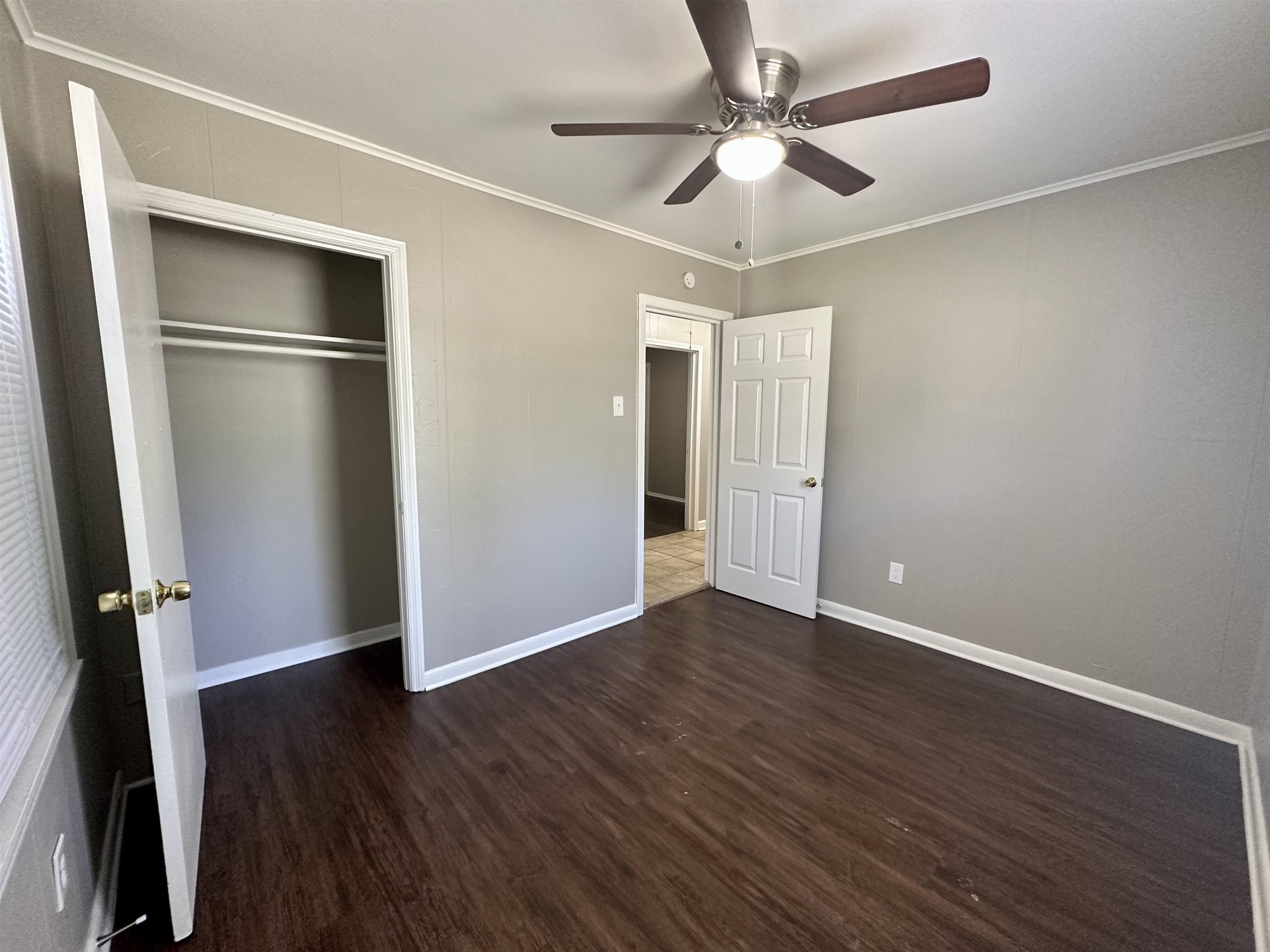 296 Glencoe Road Memphis, TN 38109 - Photo 2 of 18 an empty room with wooden floor and ceiling fan