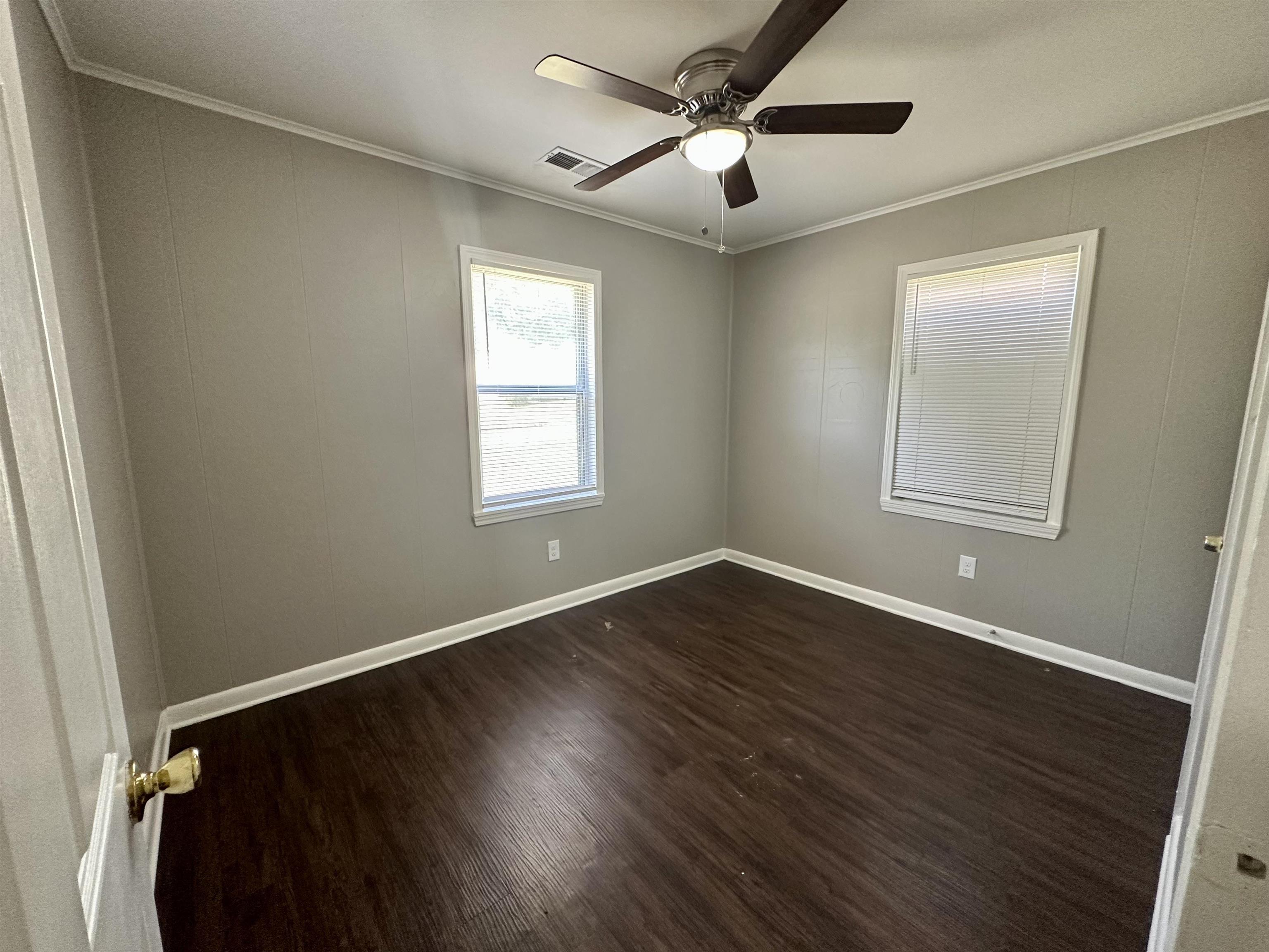 296 Glencoe Road Memphis, TN 38109 - Photo 3 of 18 a view of an empty room with wooden floor and a window