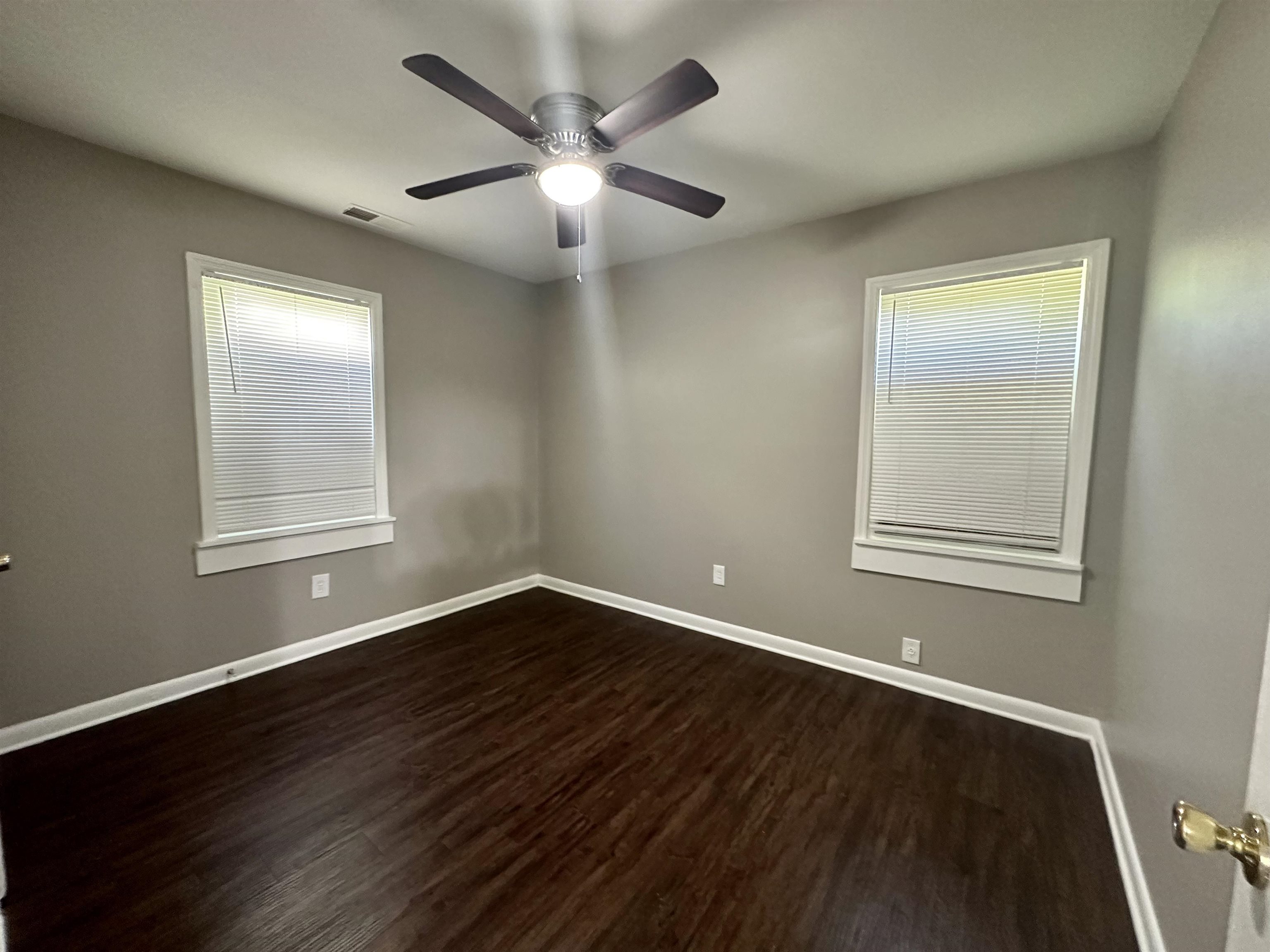 296 Glencoe Road Memphis, TN 38109 - Photo 5 of 18 a view of an empty room with wooden floor and a window