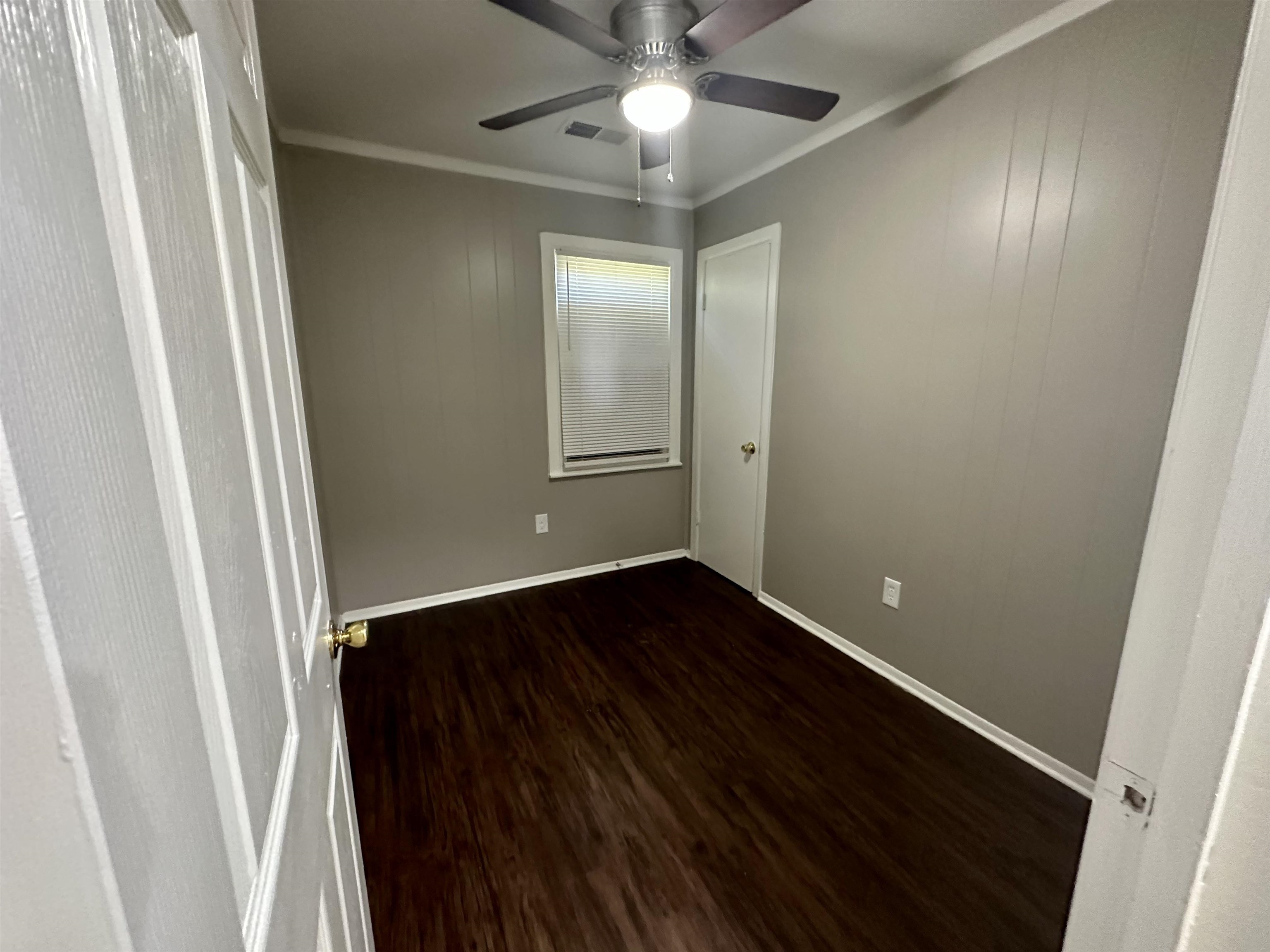 296 Glencoe Road Memphis, TN 38109 - Photo 6 of 18 a view of an empty room with wooden floor and a window