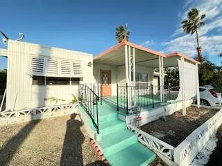 a living room with furniture gym equipment and a large window