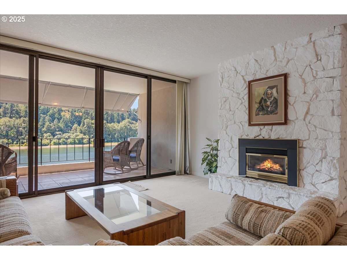 790 Southeast Webber Street, Unit 305 Portland, OR 97202 - Photo 12 of 30 a living room with furniture large window and fireplace
