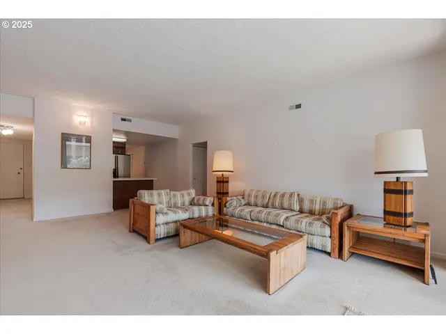 a living room with furniture and a lamp