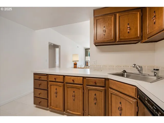 a kitchen with stainless steel appliances granite countertop a sink and cabinets