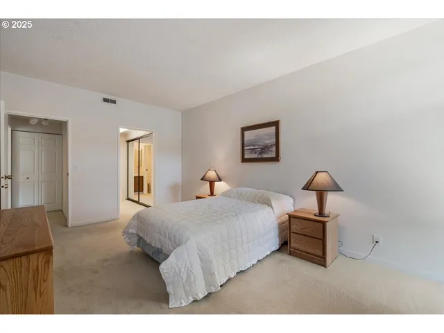 a bedroom with a bed and a lamp