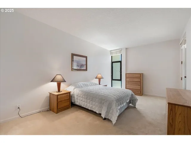 a bedroom with a bed and a lamp