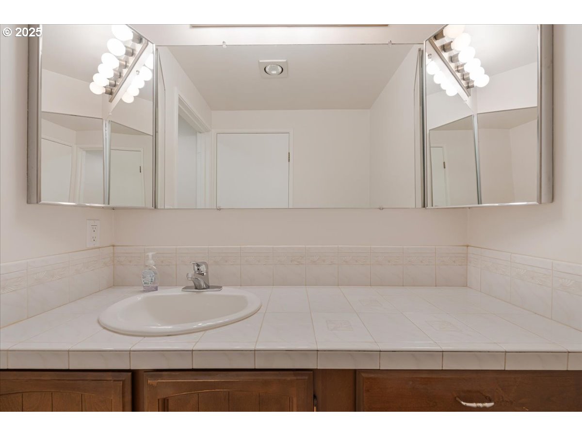 790 Southeast Webber Street, Unit 305 Portland, OR 97202 - Photo 21 of 30 a bathroom with a sink and a mirror