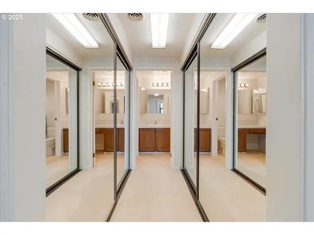 a bathroom with a glass shower door and a mirror