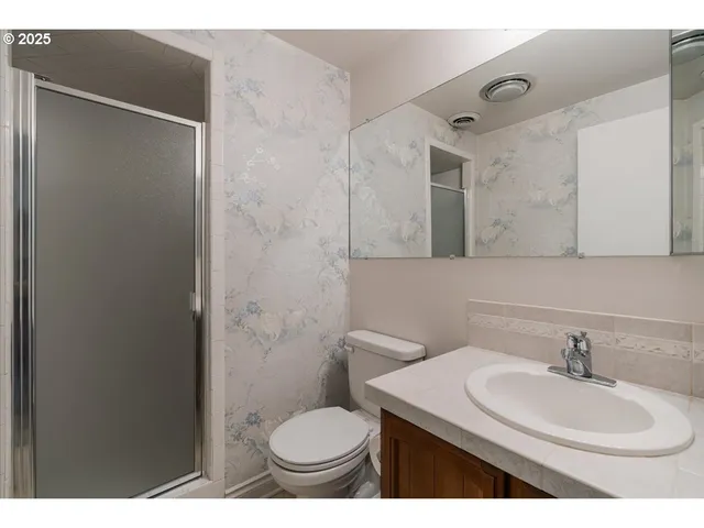 a bathroom with a sink toilet and mirror