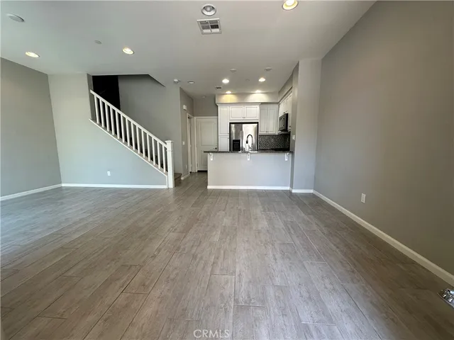 a view of a kitchen with a sink and a refrigerator