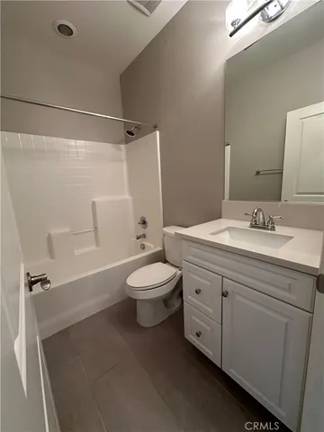 a bathroom with a double vanity sink toilet and shower