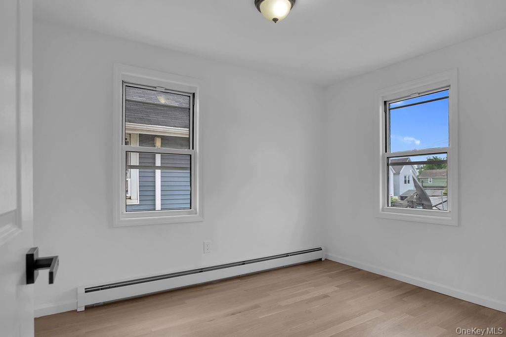 173-62 103rd Road Queens, NY 11433 - Photo 8 of 23 an empty room with windows