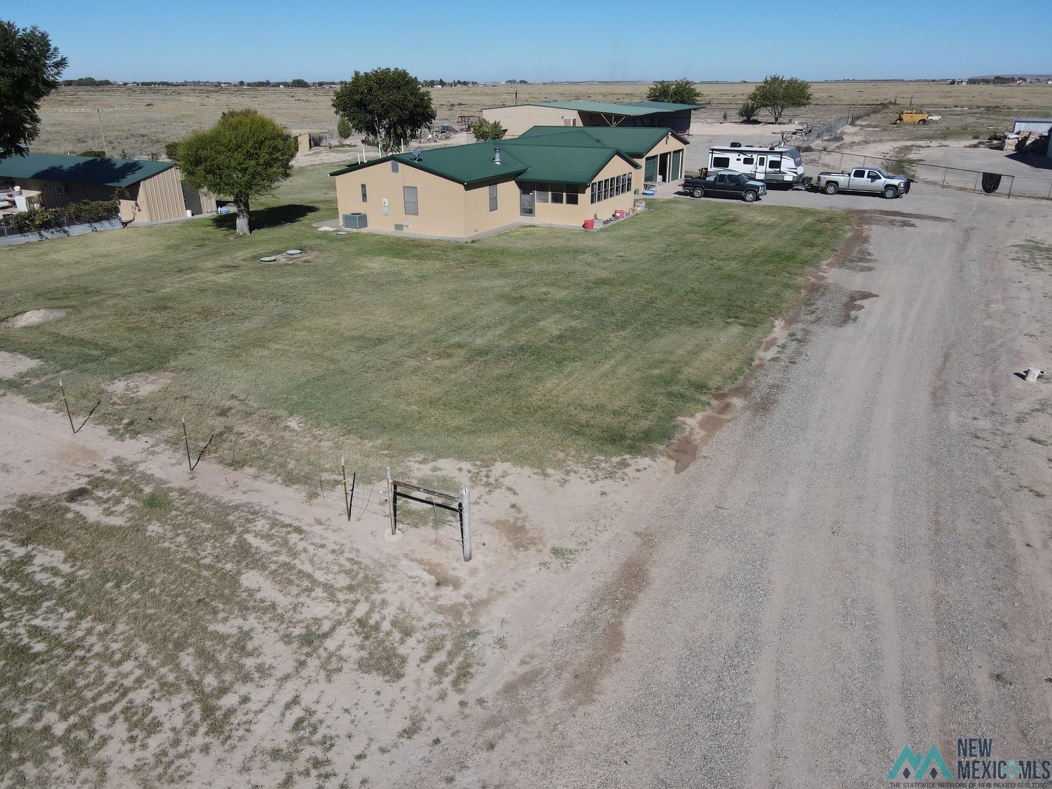 6660 Cherokee Road Dexter, NM 88230 - Photo 1 of 46 Single-story structure with a tan stucco exterior and a dark green roof