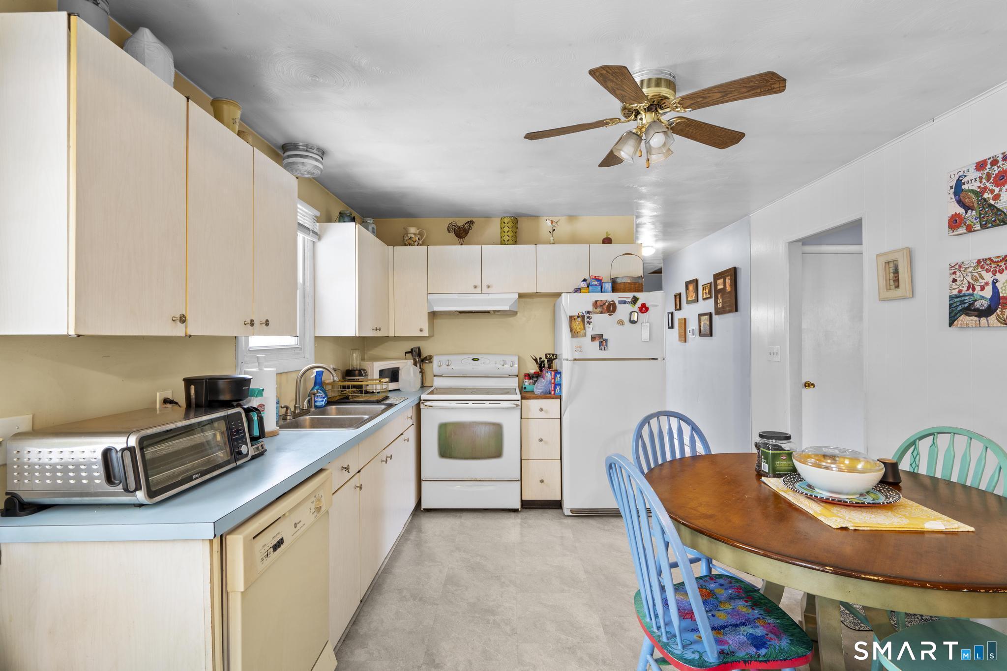 79 Forest View Drive Wolcott, CT 06716 - Photo 14 of 28 a kitchen with stainless steel appliances granite countertop a sink a stove and a refrigerator