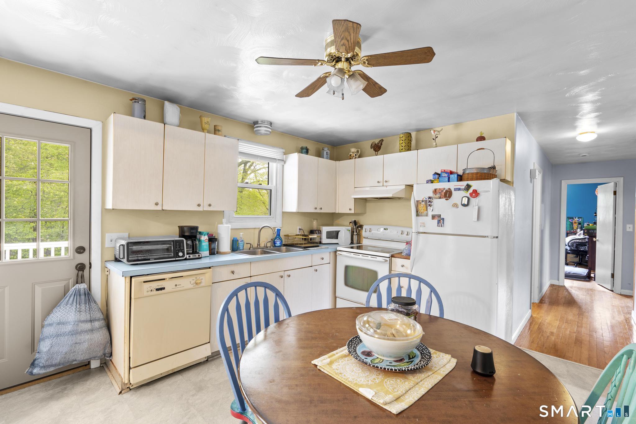 79 Forest View Drive Wolcott, CT 06716 - Photo 15 of 28 a kitchen with stainless steel appliances granite countertop a dining table chairs refrigerator and sink