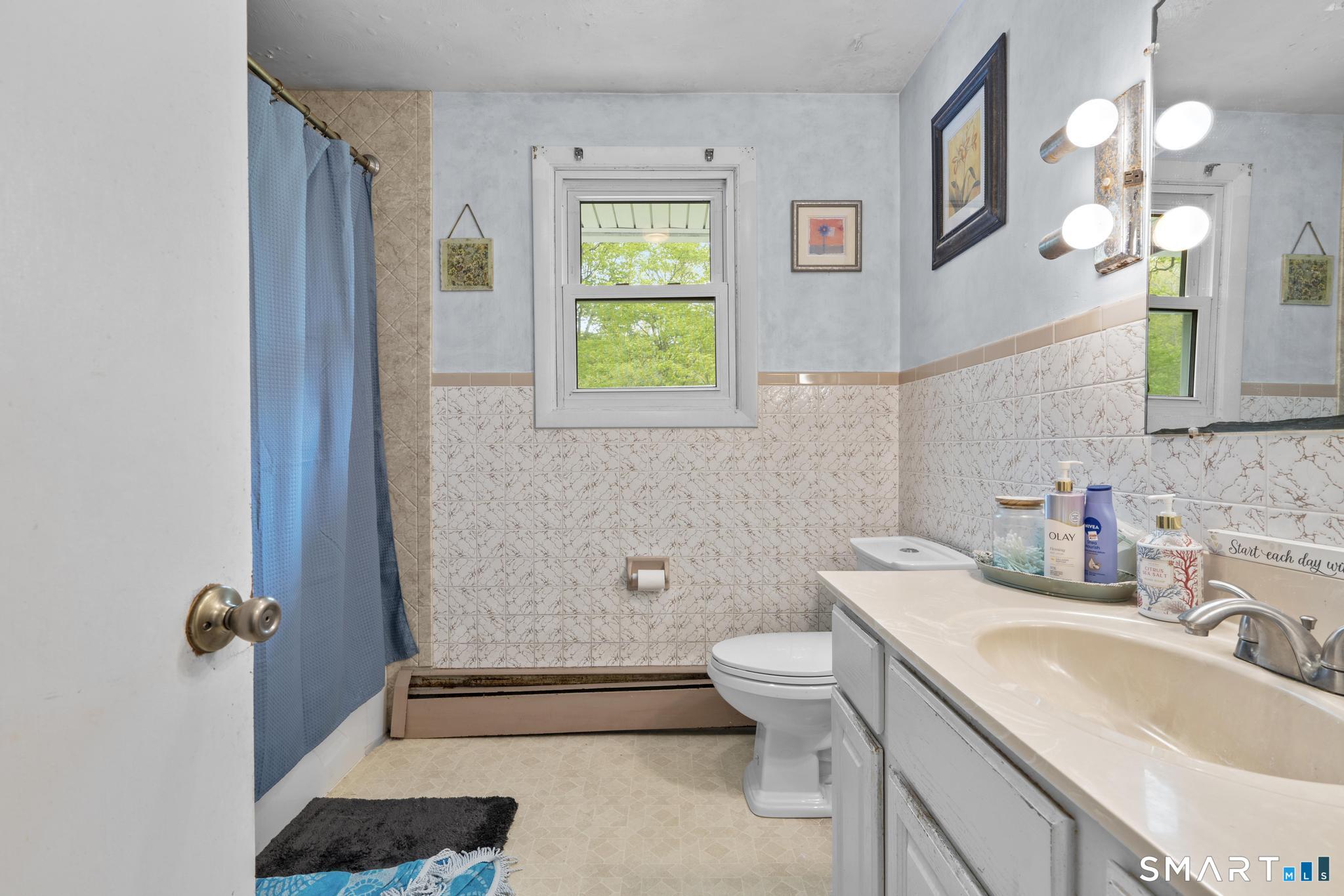 79 Forest View Drive Wolcott, CT 06716 - Photo 16 of 28 a bathroom with a sink a toilet and mirror