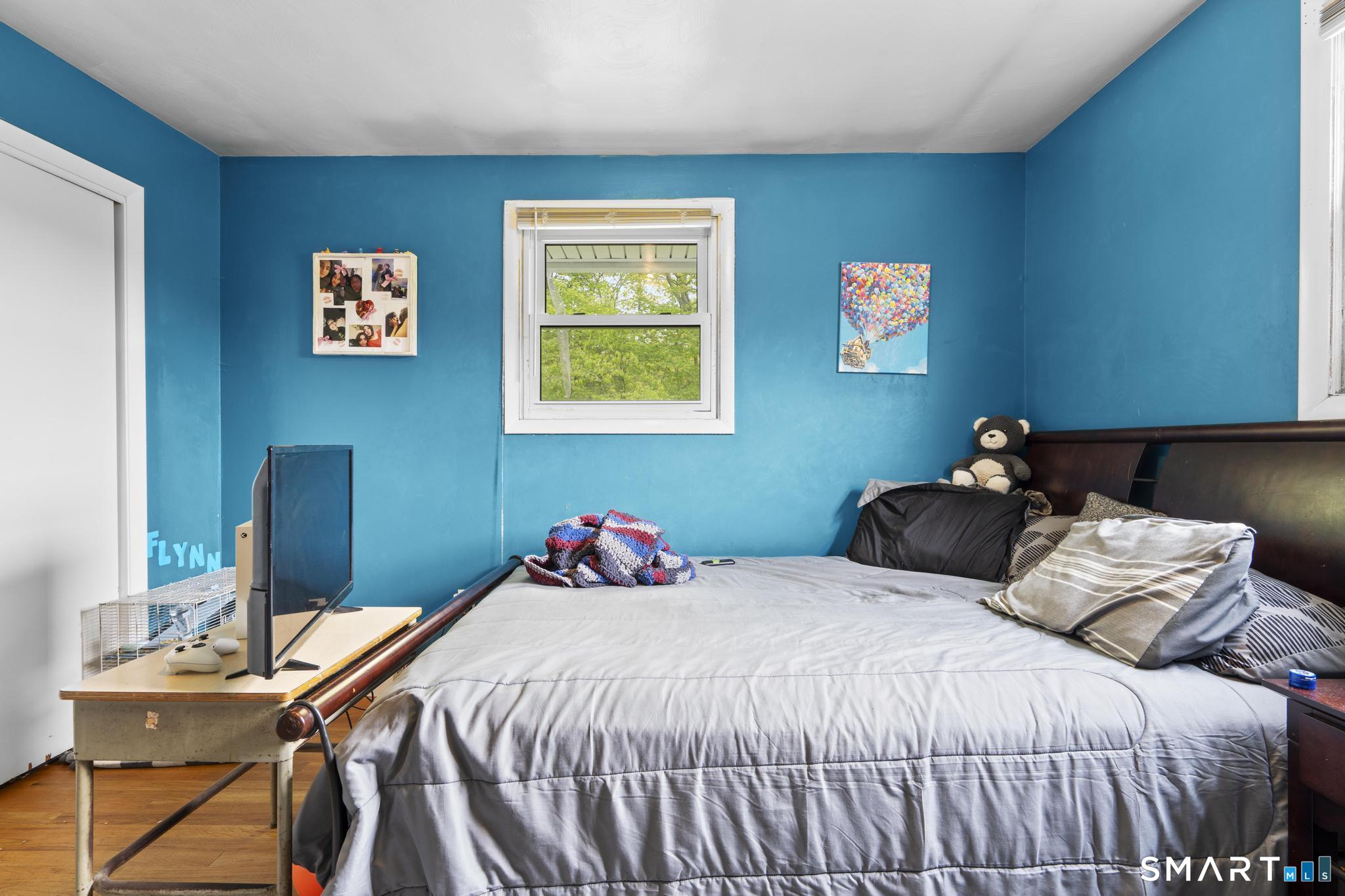 79 Forest View Drive Wolcott, CT 06716 - Photo 21 of 28 a bedroom with a bed and a table in it